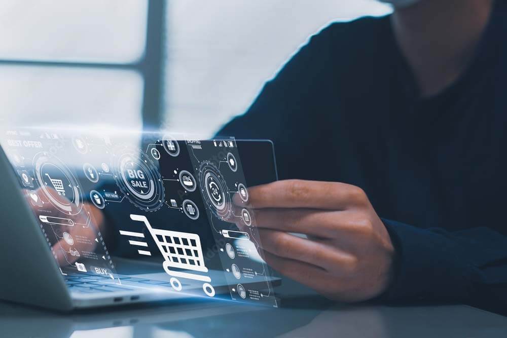 a man sitting infront of a computer making a purchase
