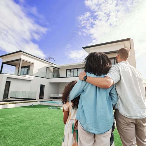a family standing infront of a beautiful home